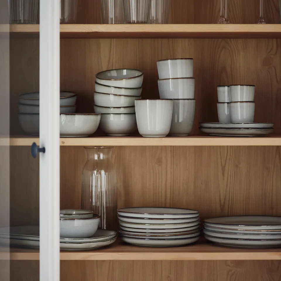 GLADELIG, grey stoneware cups, simple design, medium size, neatly stacked.