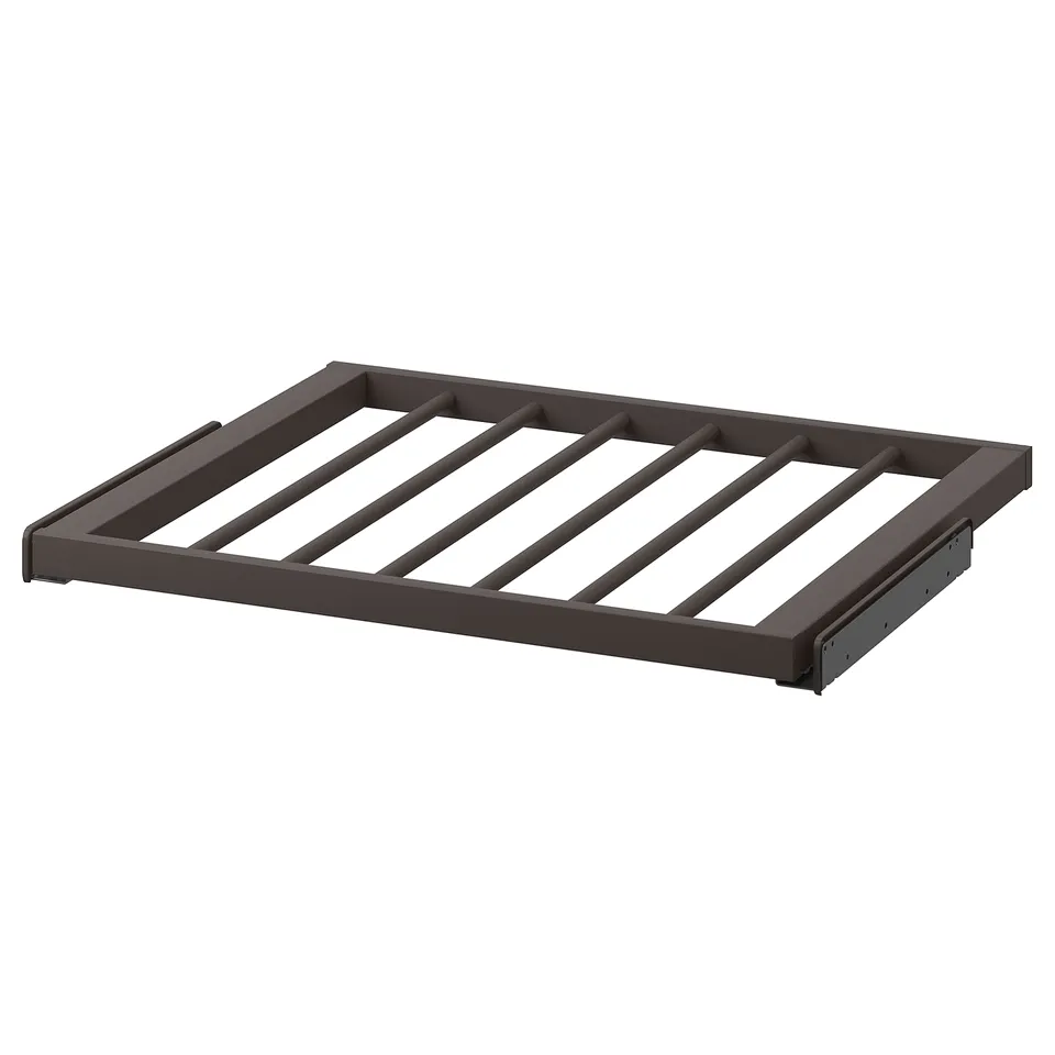 A dark grey KOMPLEMENT trouser hanger, designed with diagonal slats on a steel frame. It a smooth, epoxy powder-coated finish.