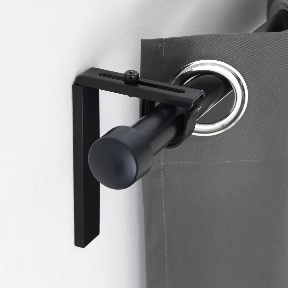 Curtain rod holder mounted on wall, adjusting curtain position, pairs with räcka or hugad rods.