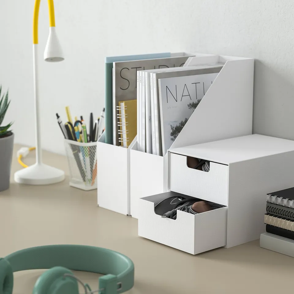 White FJÄDERHARV mini chest on desk, made of recycled paperboard, for organising small office items.