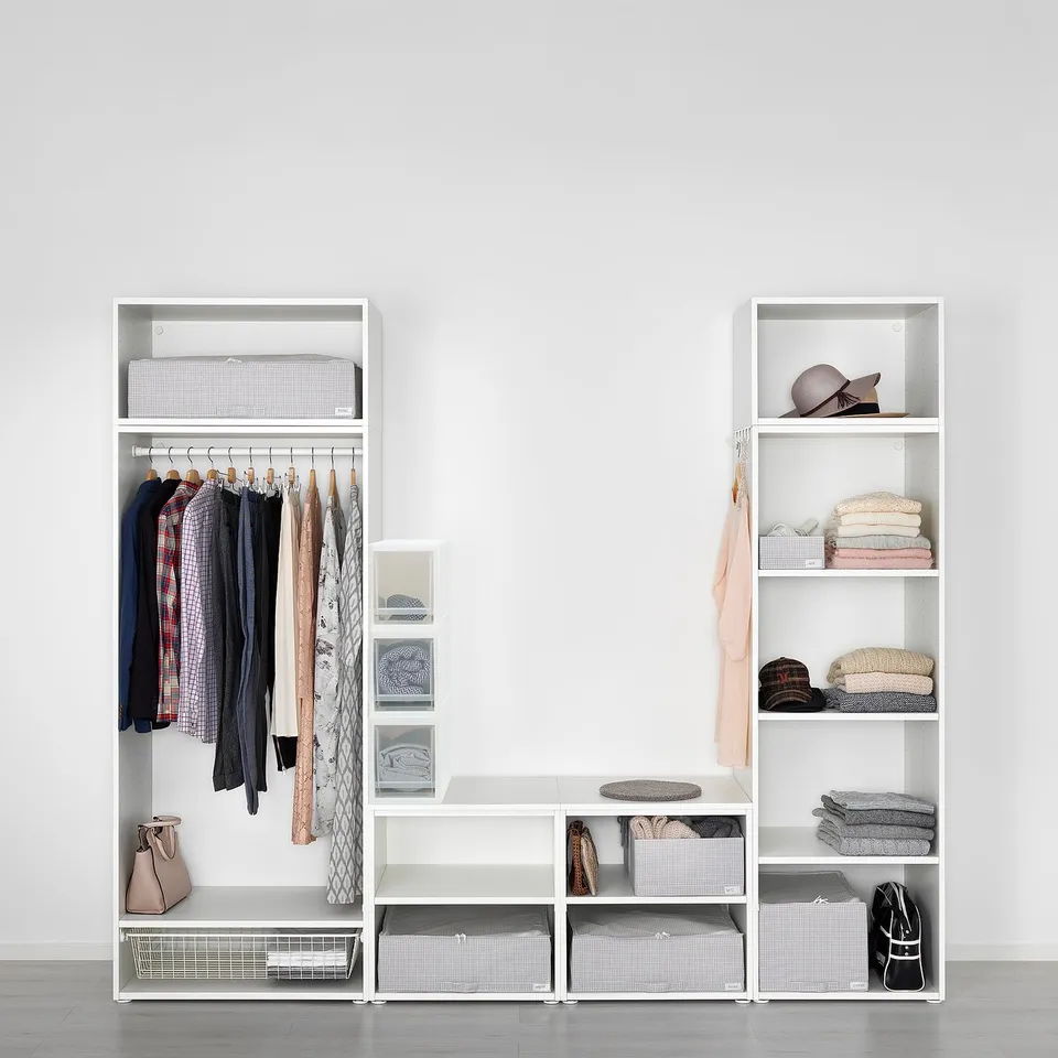 Well-organized closet with clothes, accessories, and storage bins, featuring pull-out shelves for easy access.