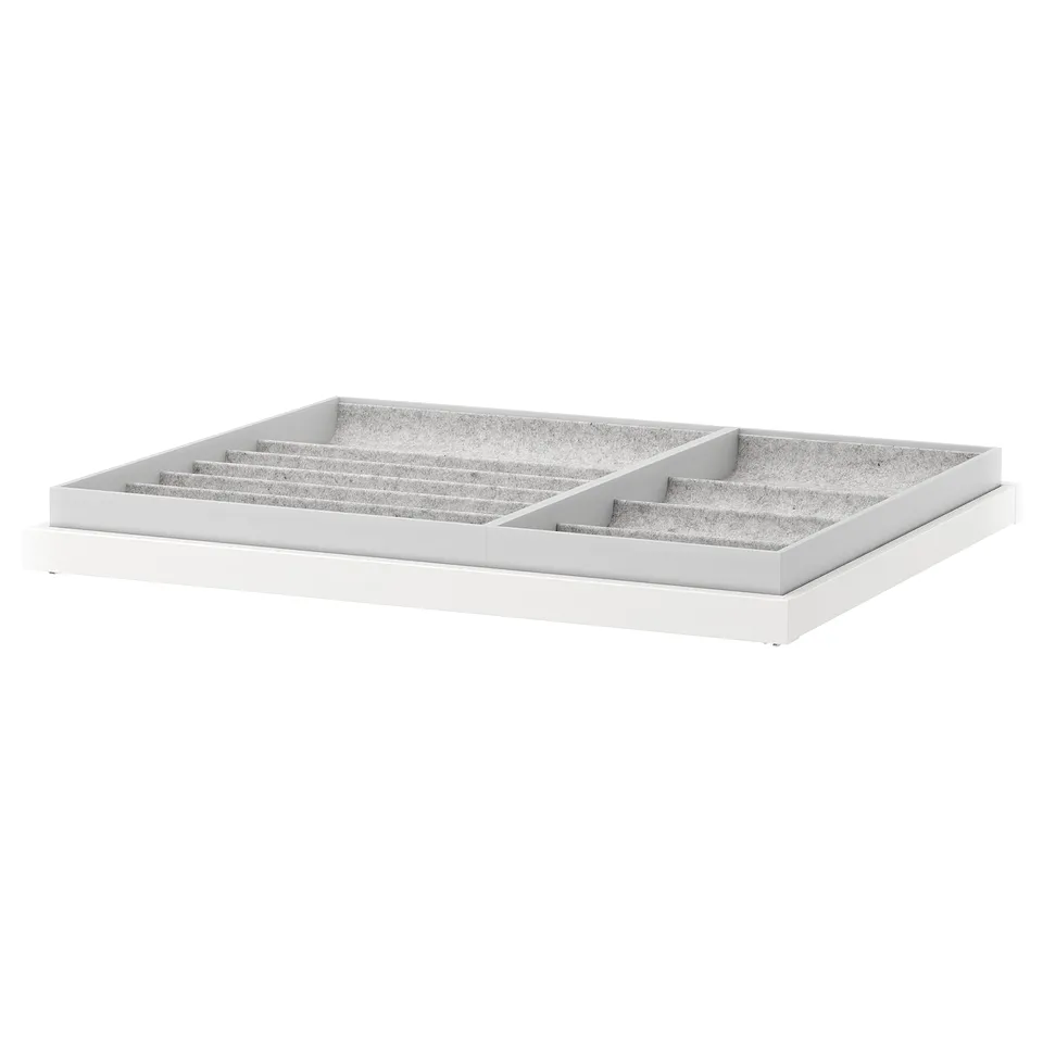A white KOMPLEMENT tray, featuring multiple compartments for jewellery and accessories, covered in felt to protect items.