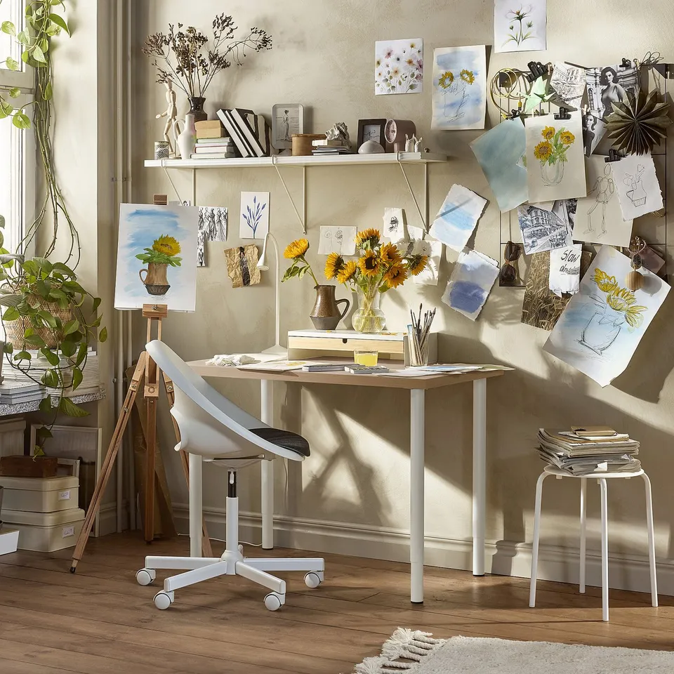 Art studio with LINNMON table, supplies, and natural light.