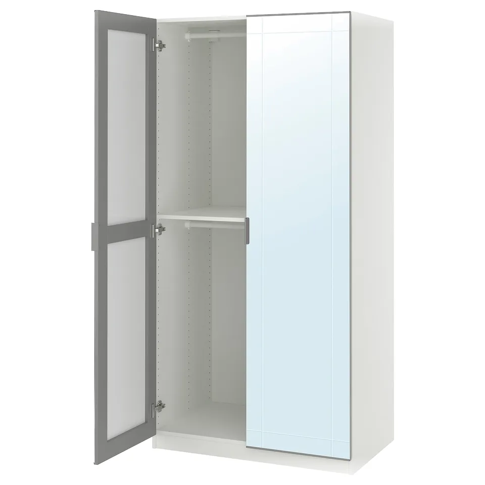 A white ikea PAX wardrobe with grey trim. It has mirrored doors, a hanging rail, and adjustable shelves inside.