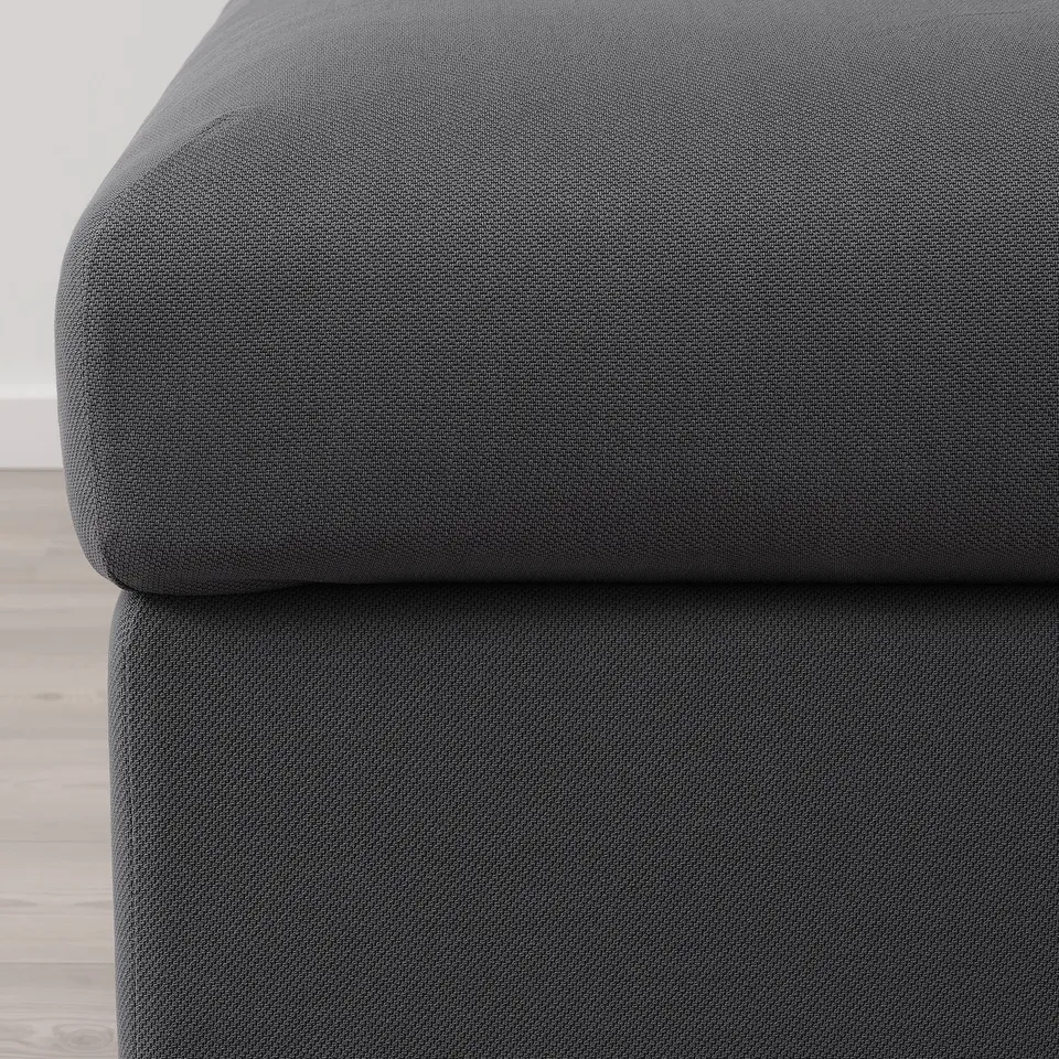 Image shows a close-up of a soft, dark grey couch with smooth, durable fabric, highlighting its comfortable and high-quality texture.