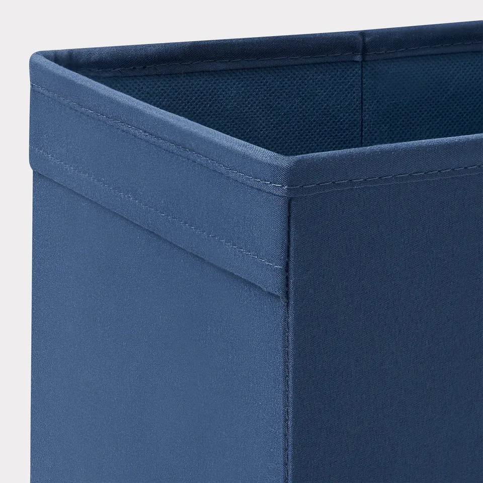 Close-up of sturdy navy fabric storage box, showcasing durable stitching and quality material.