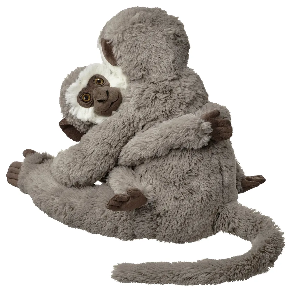 Two grey plush monkeys hugging, one smaller, soft, and cuddly, made from recycled materials.