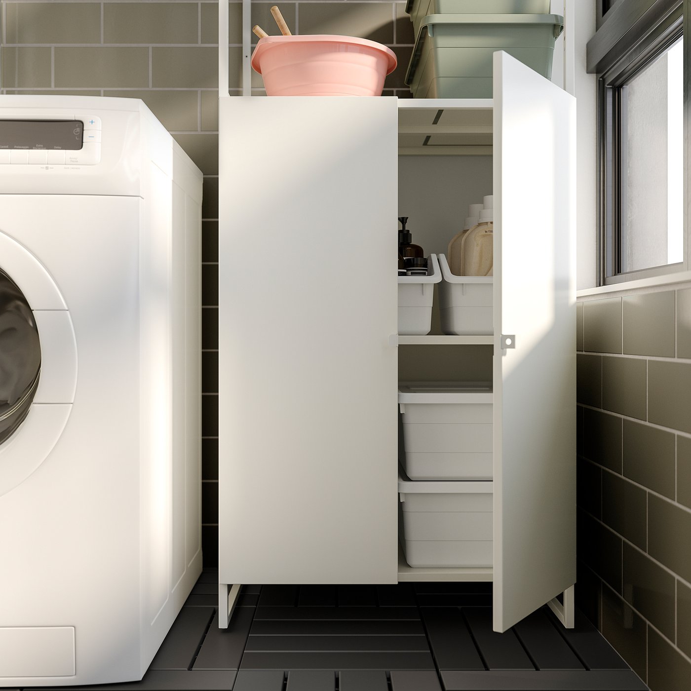 Modern white laundry cabinet with open doors, containing storage bins and cleaning supplies, next to a washing machine.