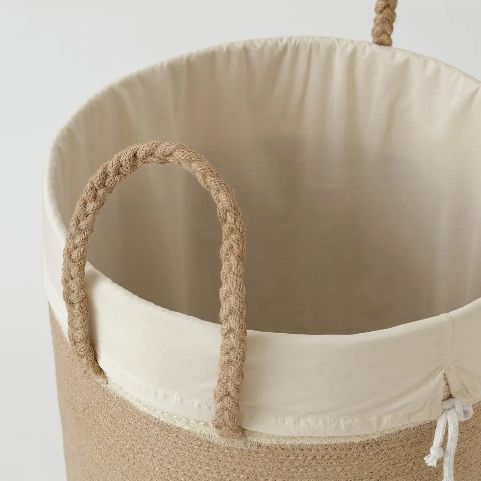 Large woven basket with braided jute handles and removable inner bag.