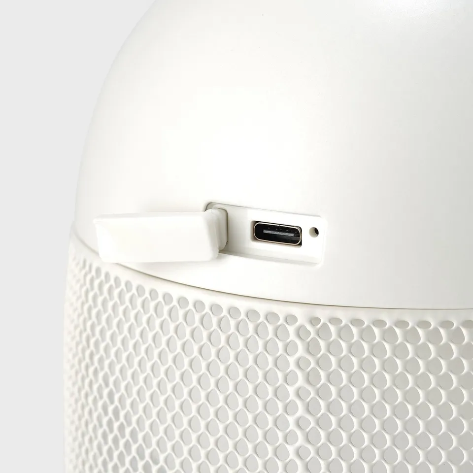 Close-up of a modern white air purifier with a usb port for easy charging.