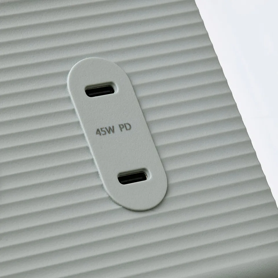 Close-up of grooved white surface with 45w pd power outlet.