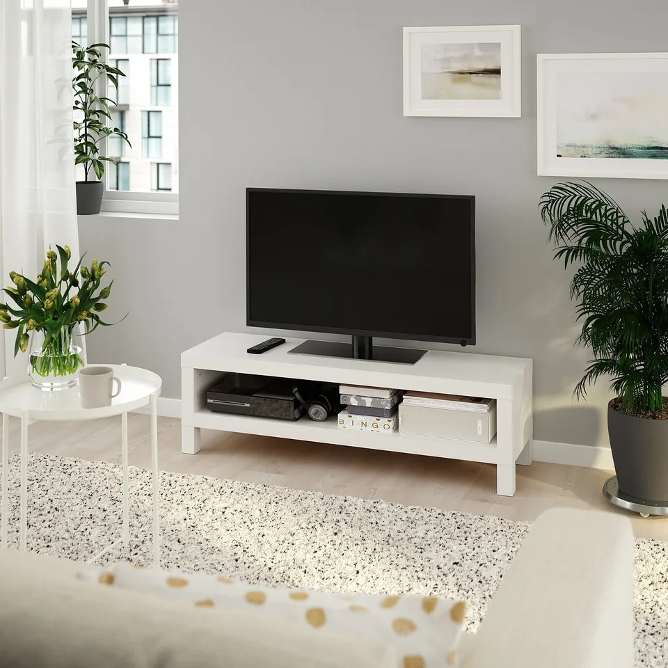 Modern living room with ikea LACK tv stand, plant, and side table.