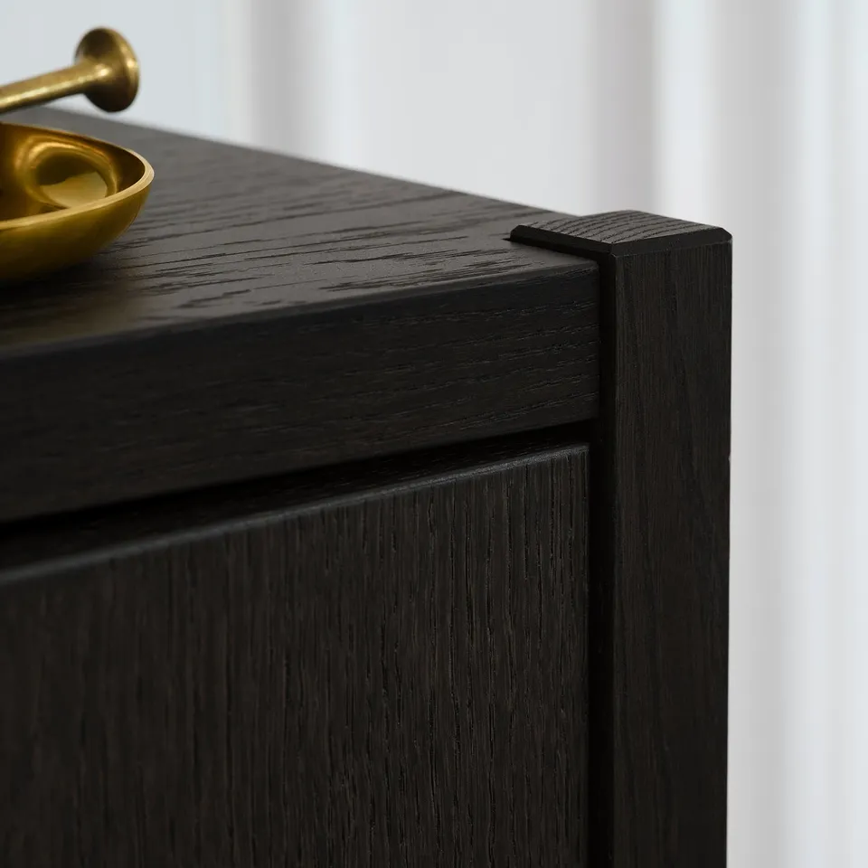 Dark wooden cabinet with smooth, polished surface; close-up shows craftsmanship and quality finish.