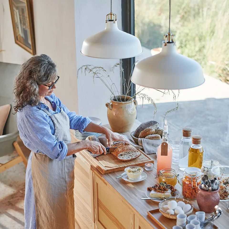 Person cooking under RANARP lamps.