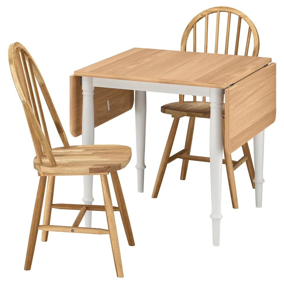 Minimalist light wood drop-leaf dining table with two matching chairs.