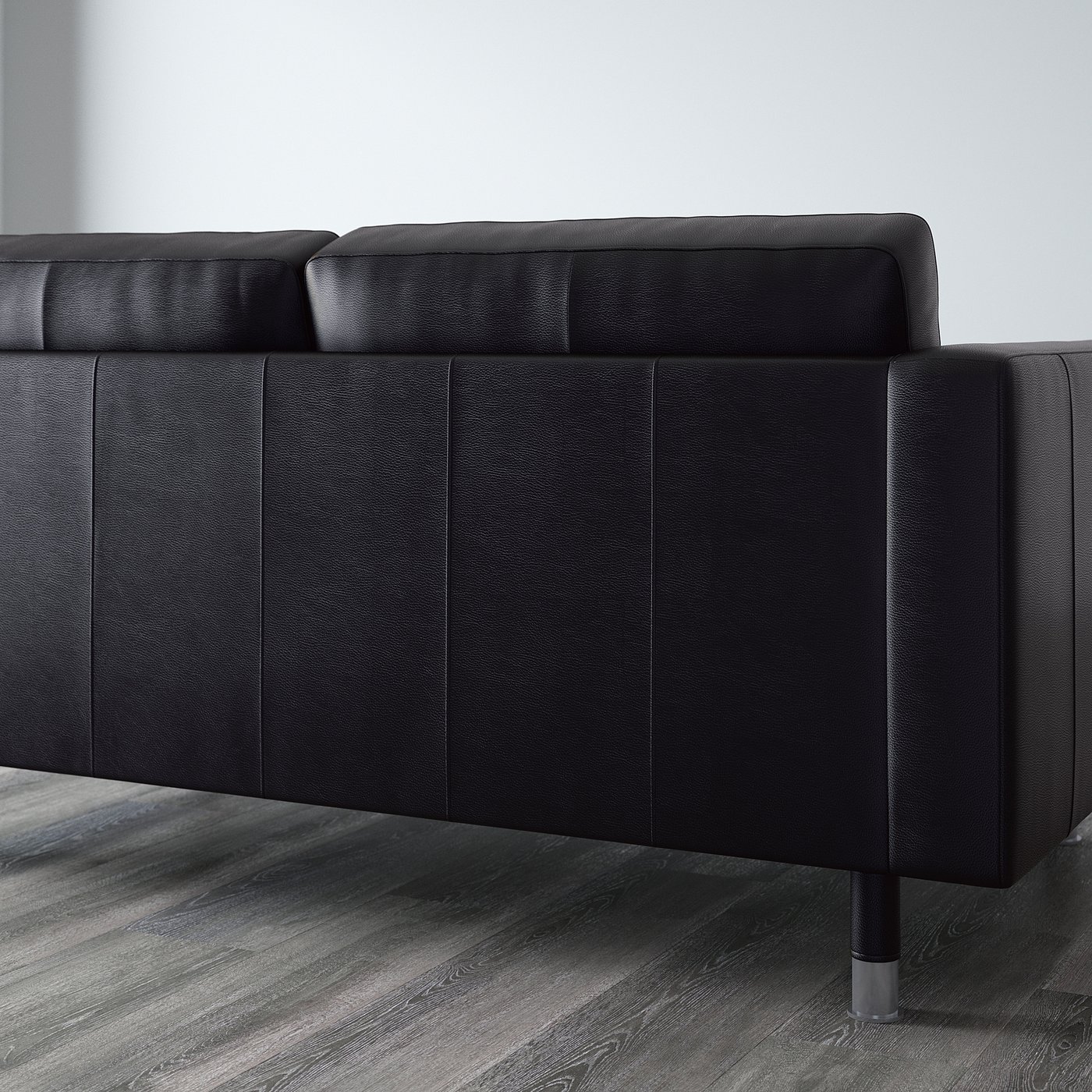 Black leather sofa with clean lines and metal legs, part of landskröna series, known for comfort and durability.