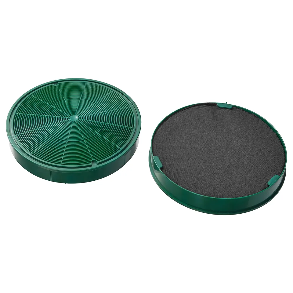 Two green circular philtres with charcoal layers, one showing mesh design and the other the solid charcoal surface.