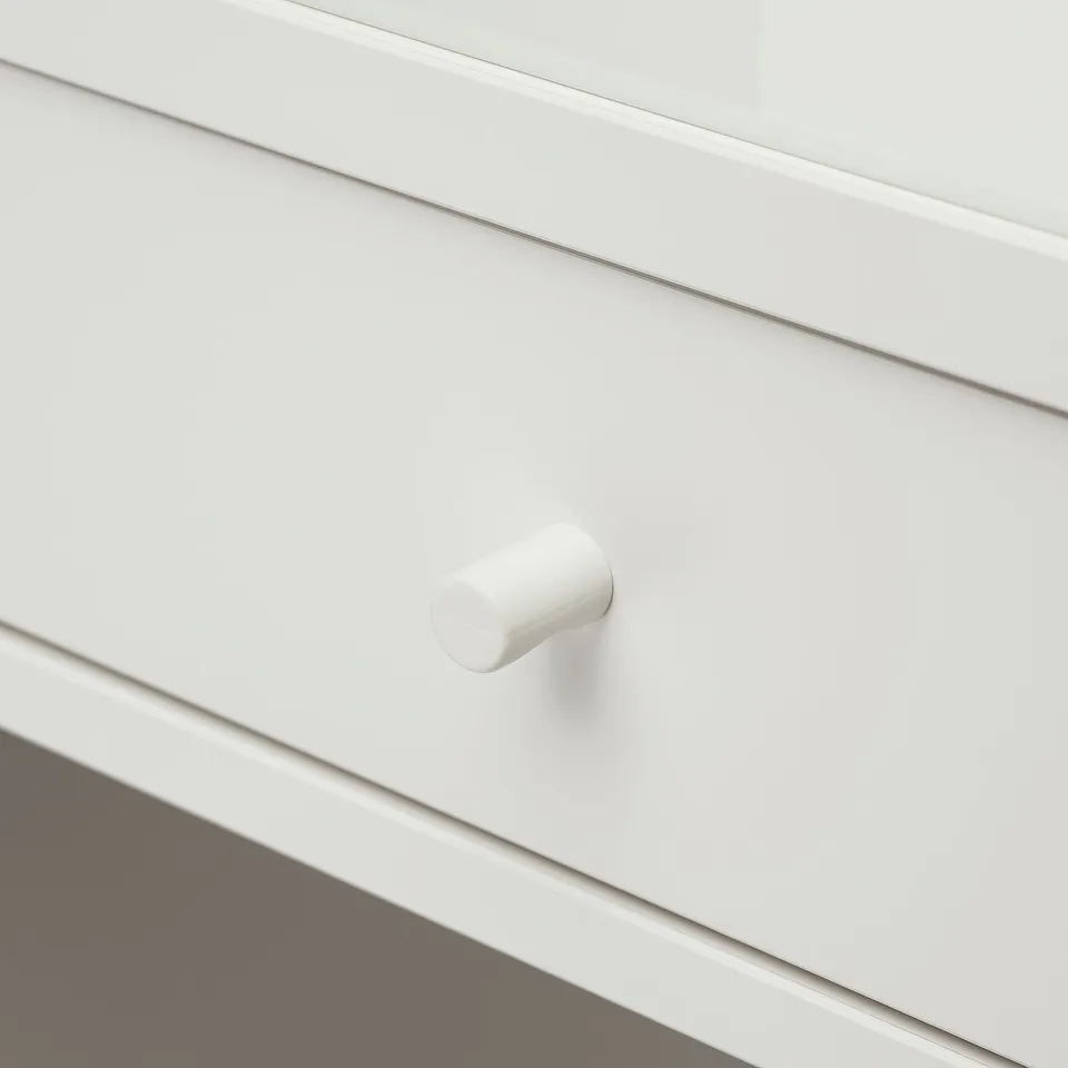 Close-up of a sleek, white drawer with a smooth, modern handle, part of a stylish dressing table.