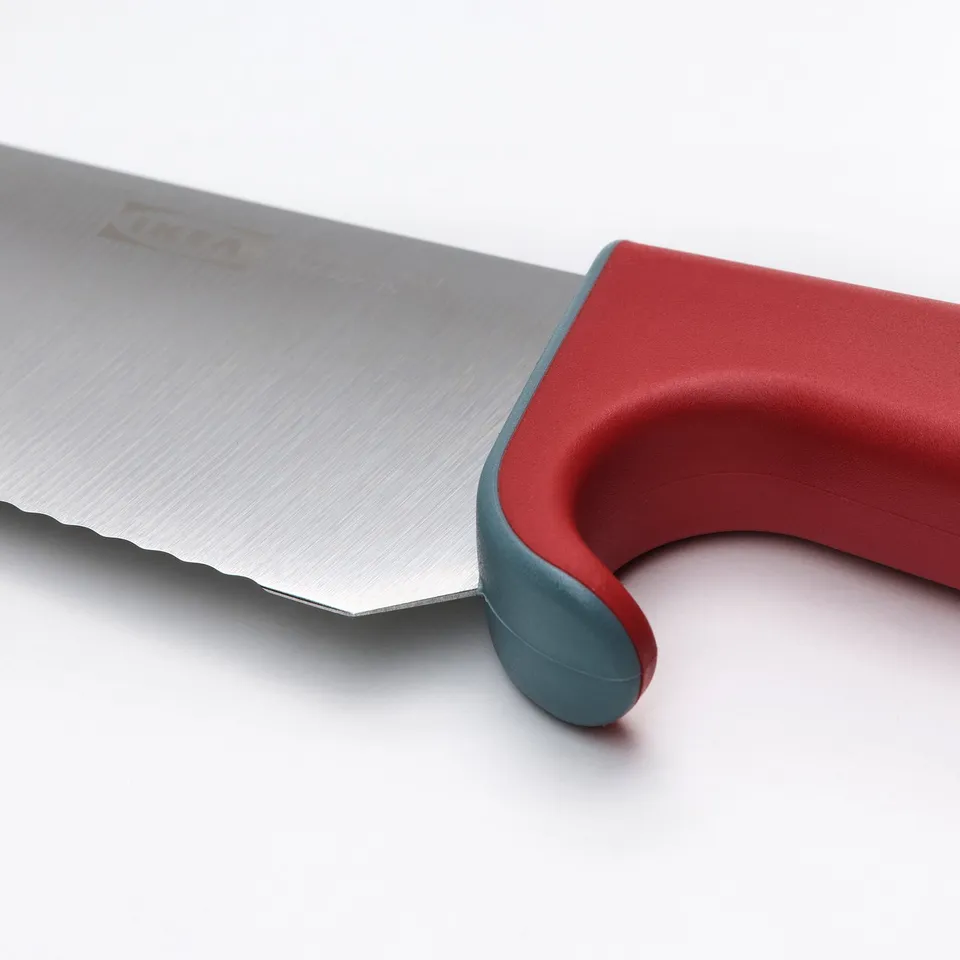 Close-up of a high-quality childrens knife with a red handle and blade protector, showcasing its safety.