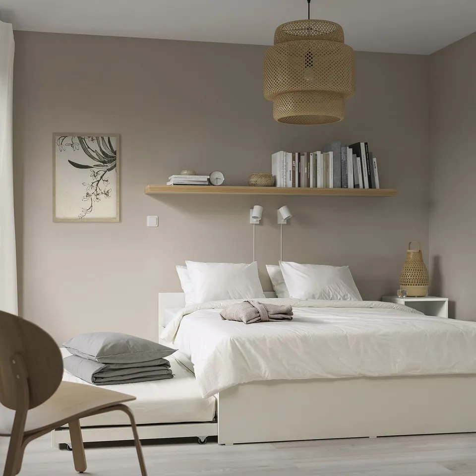 Bedroom with white VIHALS bed, grey walls, wooden chair.