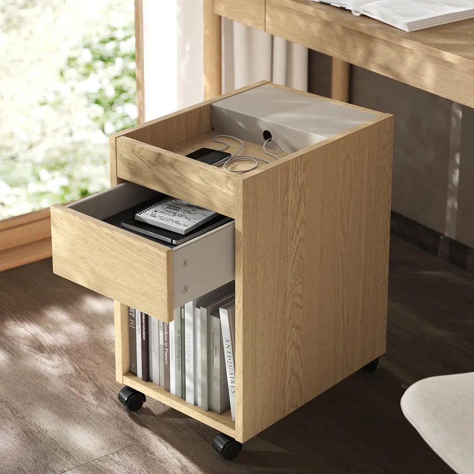 Wooden mobile storage unit with open drawer and bookshelf. Soft-close drawer and practical castors for easy movement.