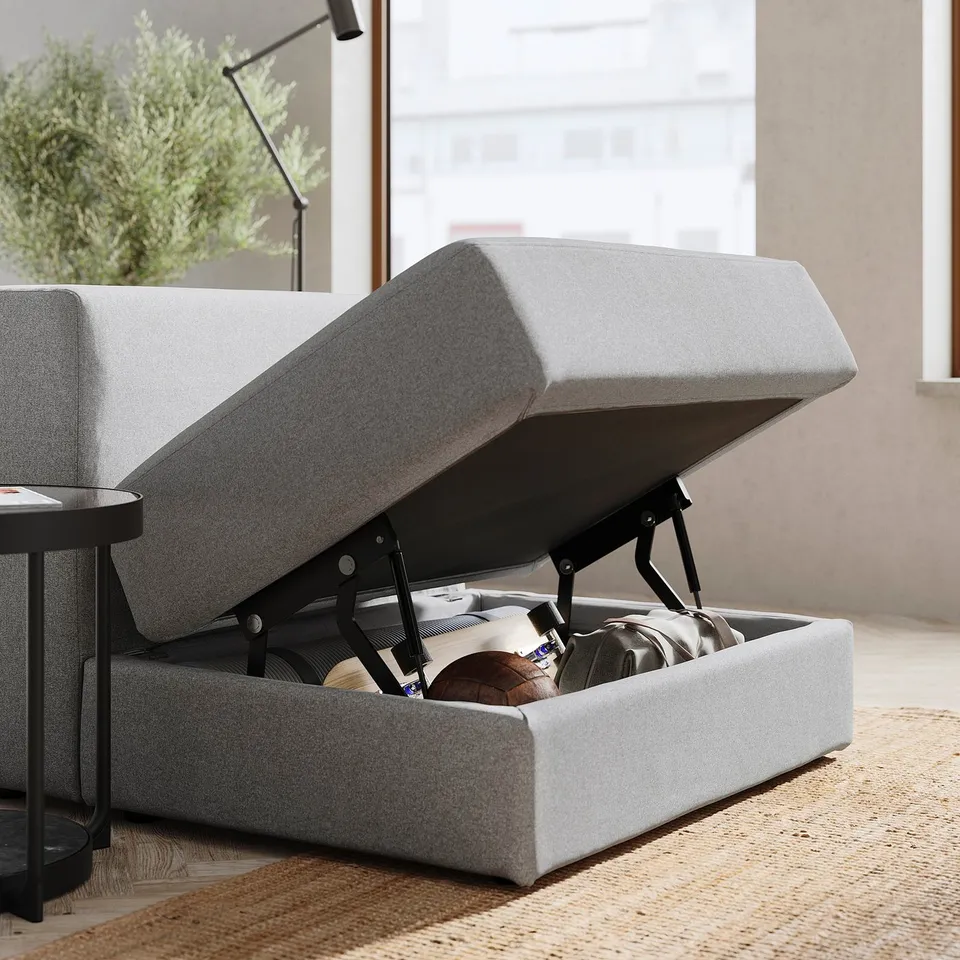Modern grey fabric sofa with storage. Soft cushions, clean lines, practical under-seat space.
