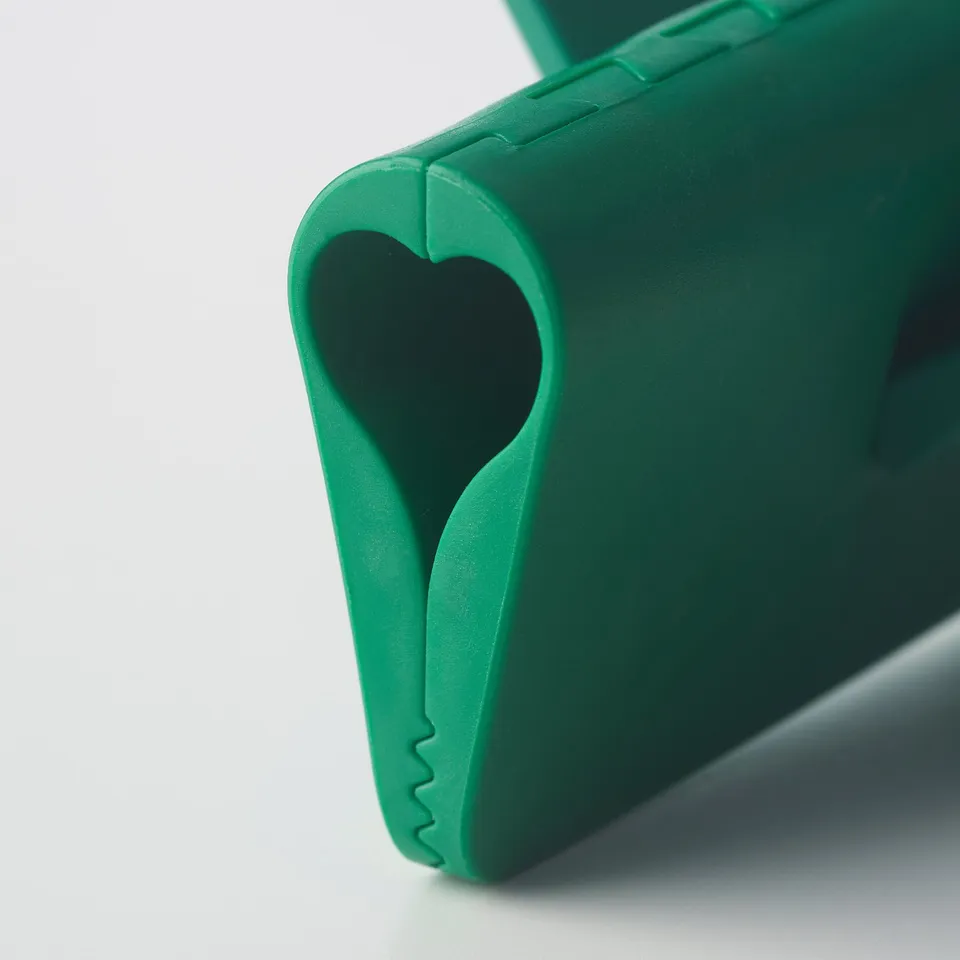 Bright green plastic bag seal clip, designed with a heart-shaped cutout, shown in close-up, highlighting its sturdy and colourful construction.