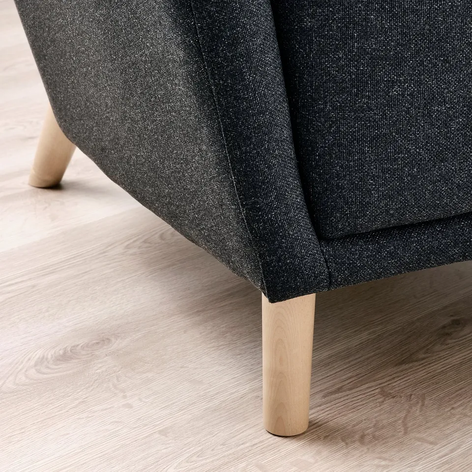 Comfortable wing chair, high back, wooden legs, cosy texture.