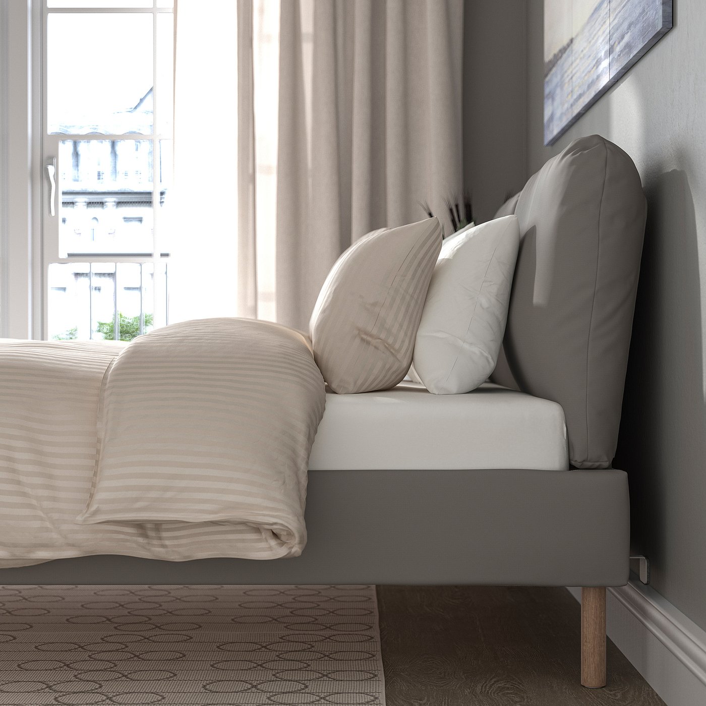 Modern bed with soft pillows, removable cover, and wooden legs, ideal for relaxation.