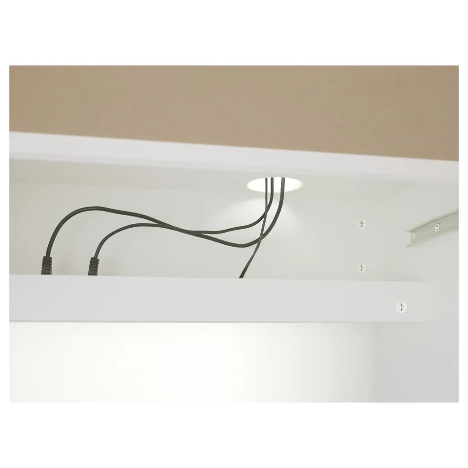 Desk with rear cable outlet, organised cords and adjustable shelves.