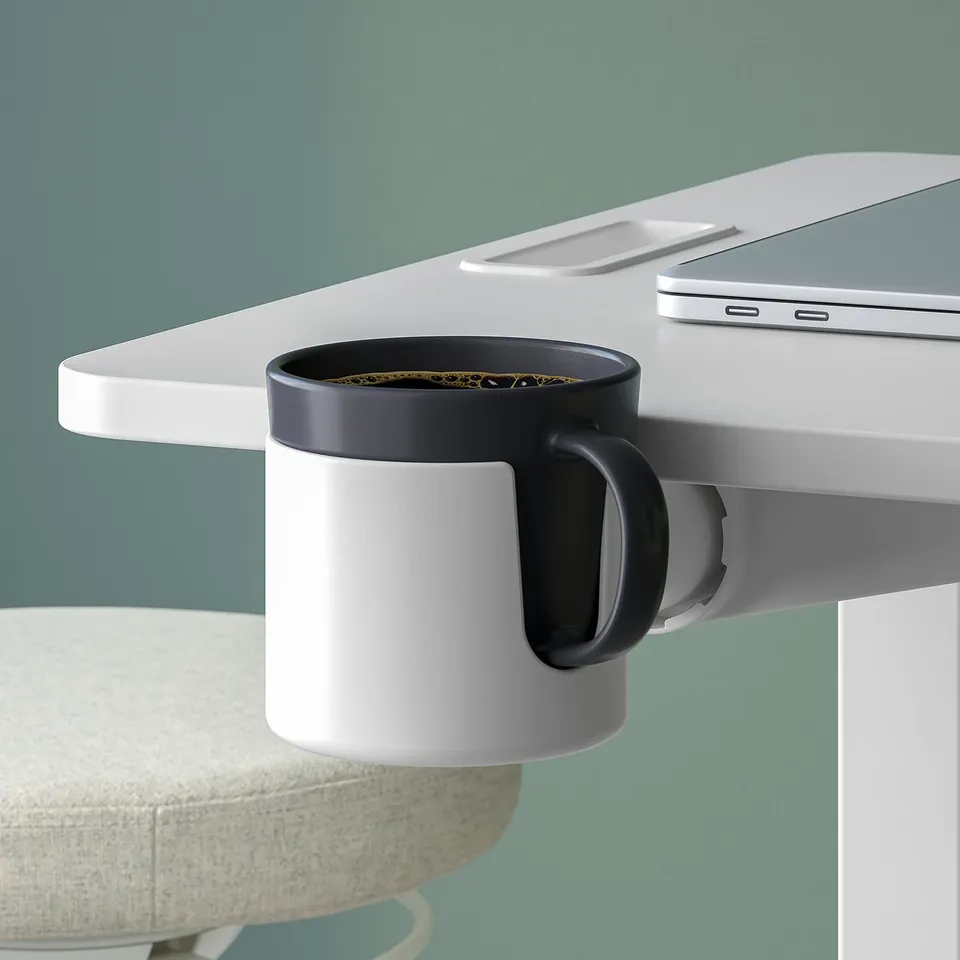 A height-adjustable laptop table with a cup holder, shown with a mug and a laptop.