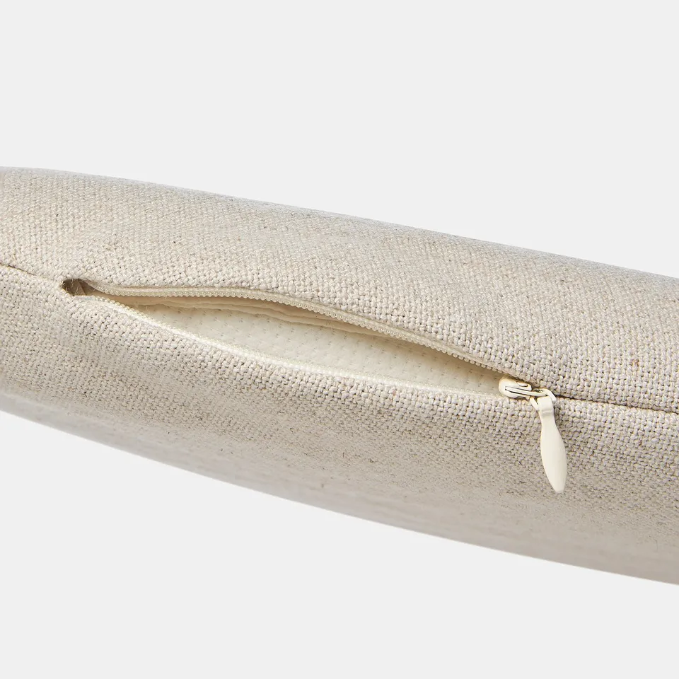 Close-up of beige woven cushion zip, soft and removable cover.