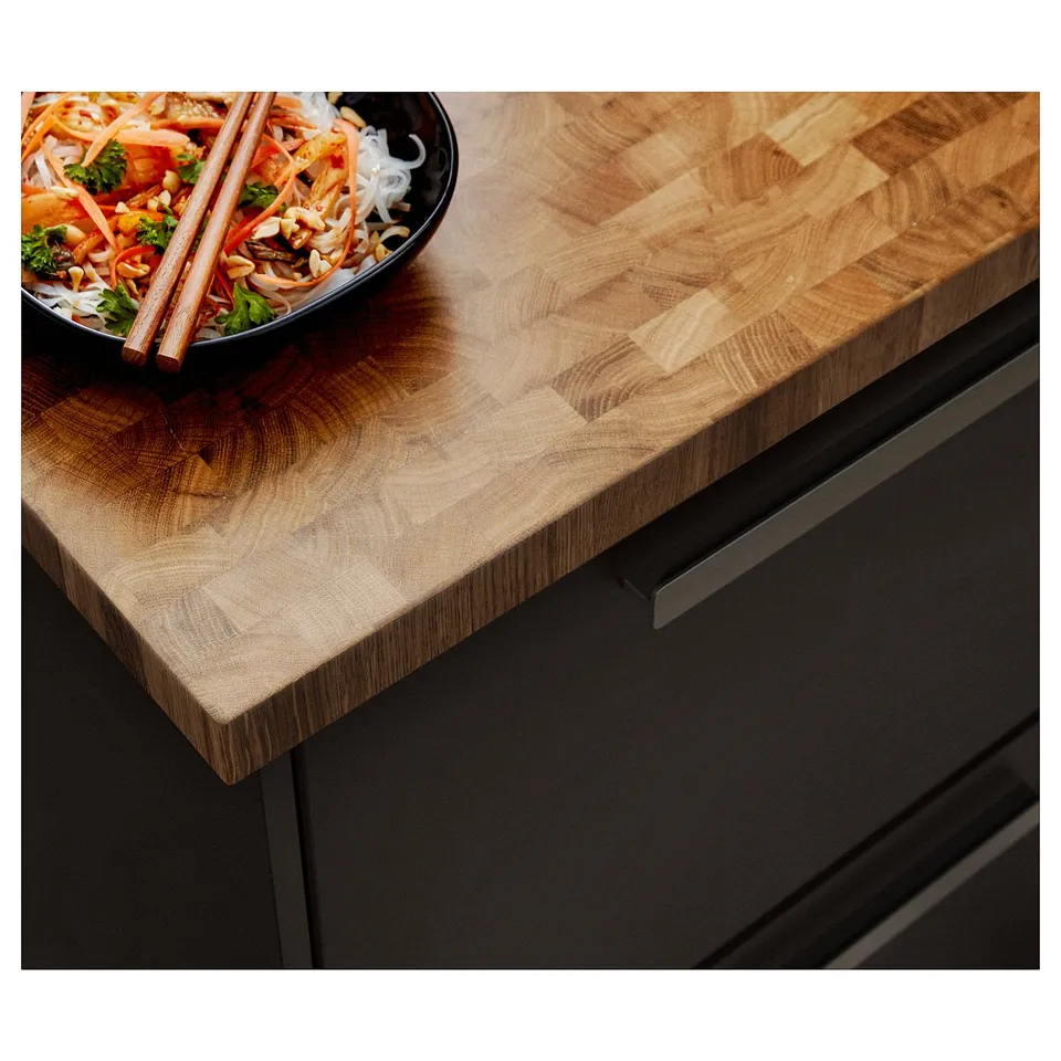 SKOGSÅ wooden countertop with black drawer. Nested bowl of noodles and chopsticks.