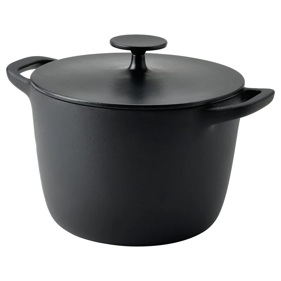 A black VARDAGEN cast iron casserole with lid, round and sturdy, ideal for slow cooking.