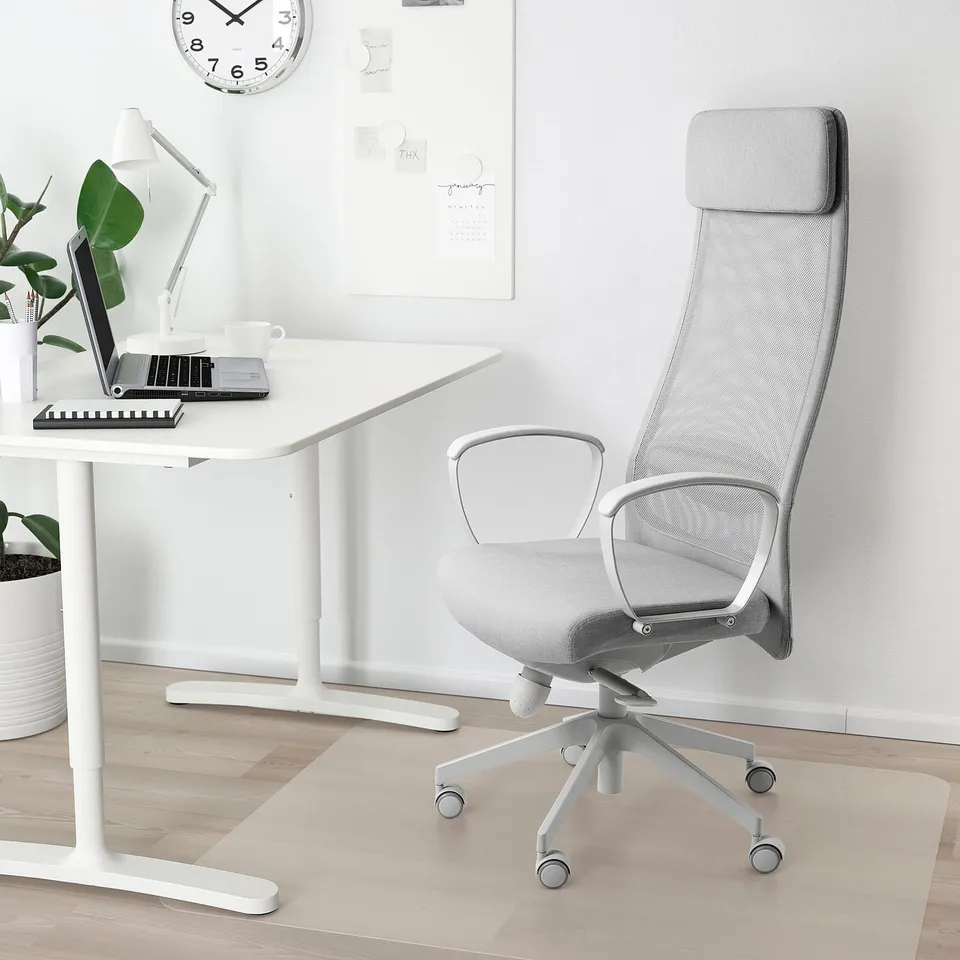 White MARKUS office chair with mesh back, high back, armrests, and caster wheels.
