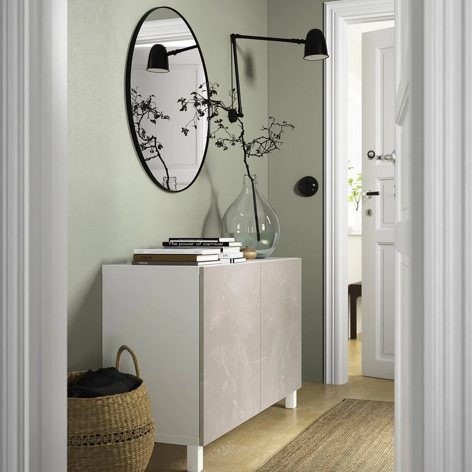 BESTÅ marble sideboard with decor: books, vase, basket, mirror, lamps.