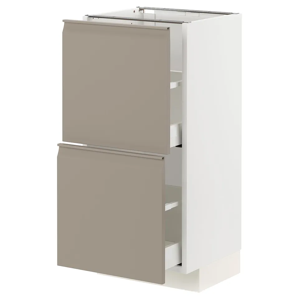 A modern white and grey kitchen cabinet from the METOD system with two drawers in a light gray-beige shade.