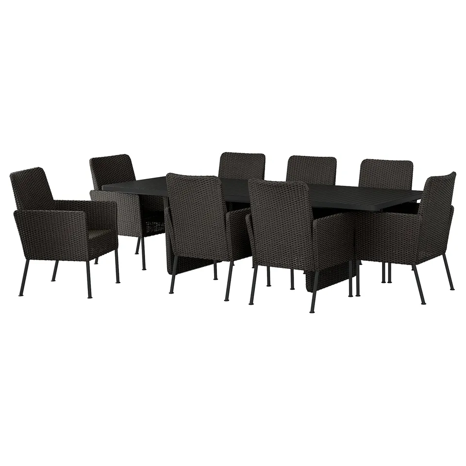 Black outdoor dining set with rectangular table and 8 wicker chairs.