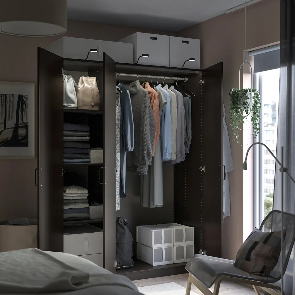 Organised wardrobe closet with clothes, shelves, and storage boxes. Modern design with dark finish, hanging garments, and clean layout.
