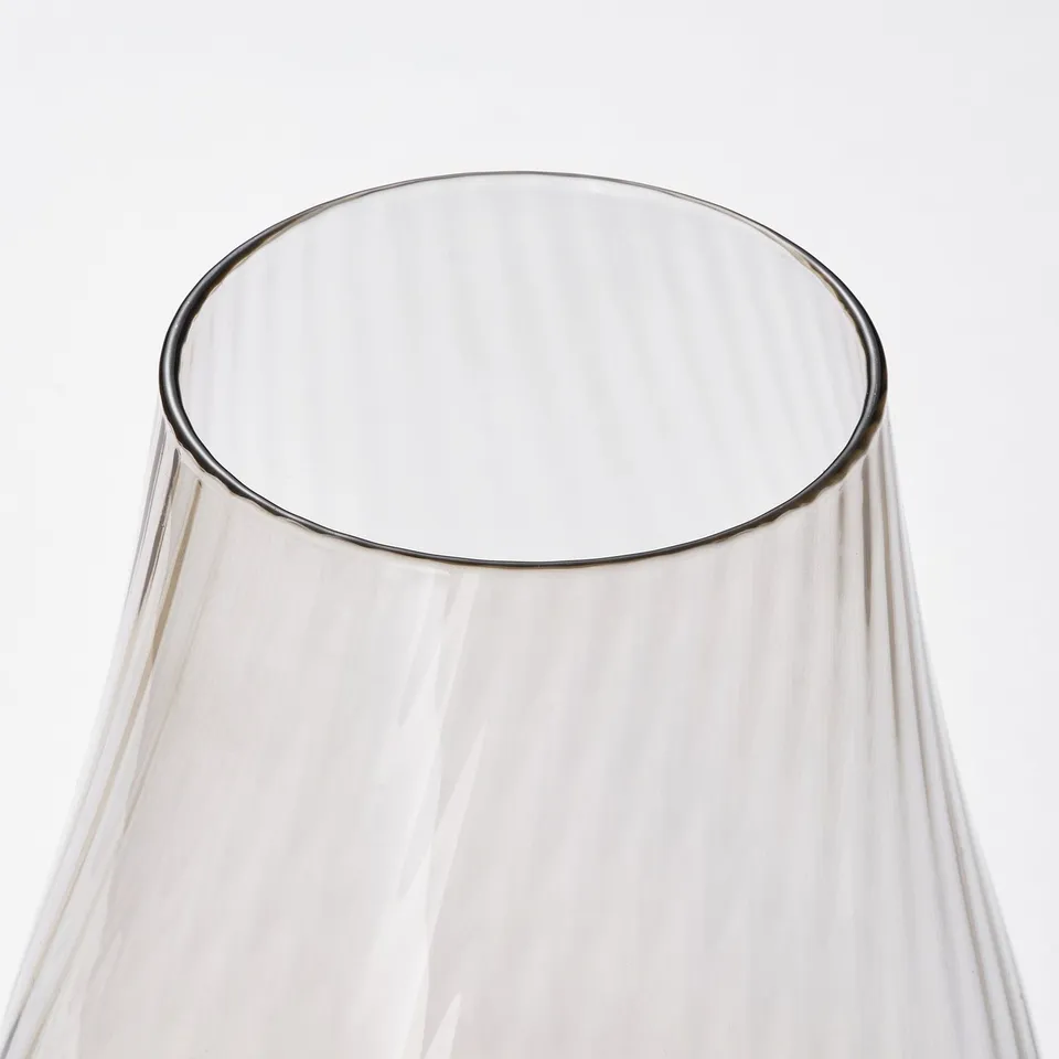 Clear, sleek glass vase with smooth, tapered design reflecting light, showcasing high quality and elegant simplicity.