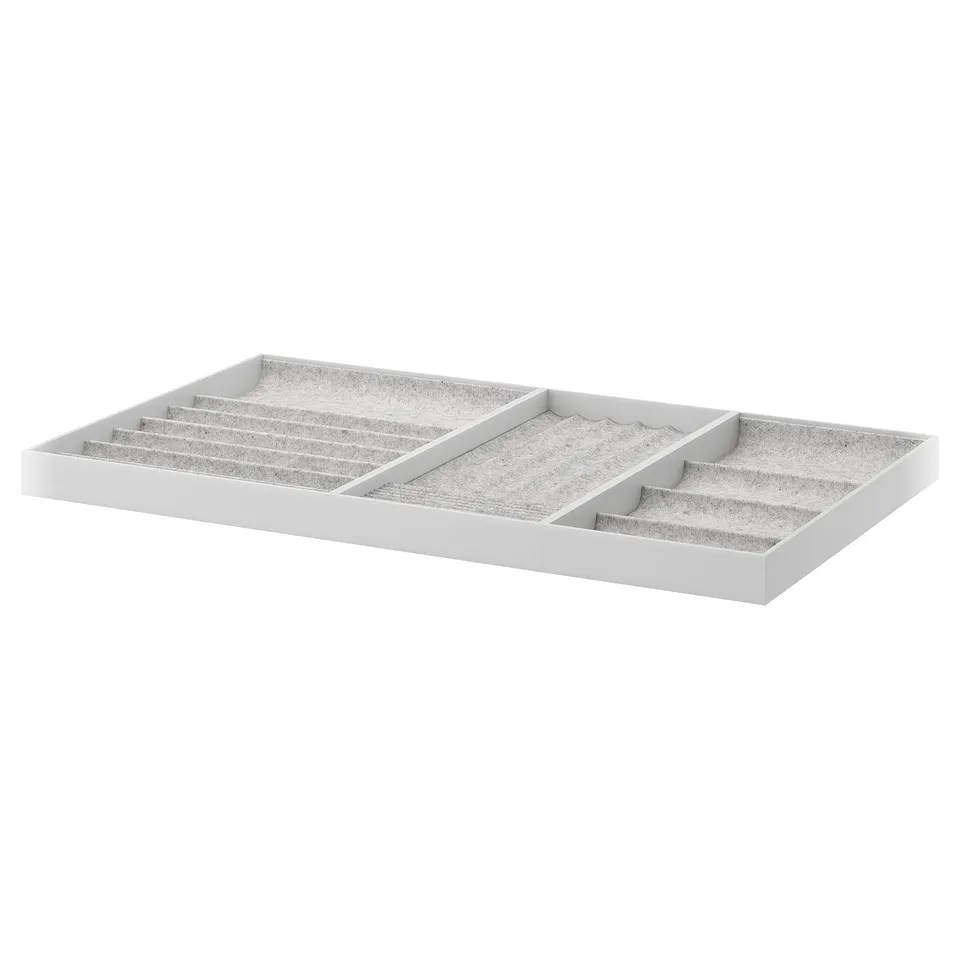 White KOMPLEMENT jewellery organiser, felt-lined compartments for necklaces, rings, and watches.