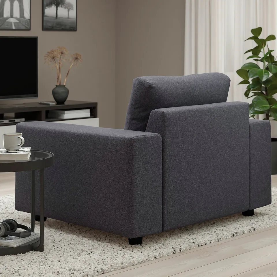 Modern grey VIMLE sofa in living room with side table, plant, and tv.