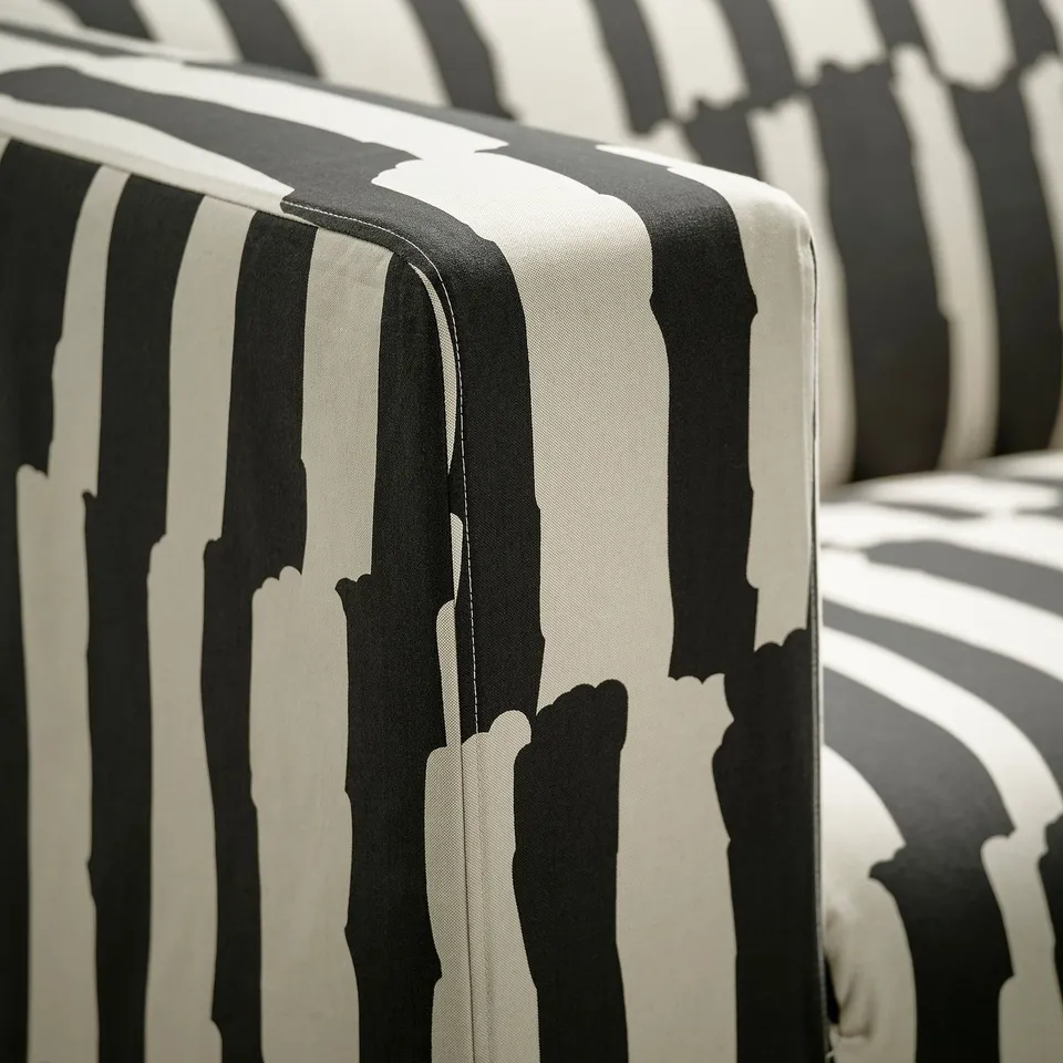 Black and white striped sofa close-up showing durable fabric and solid stitching.