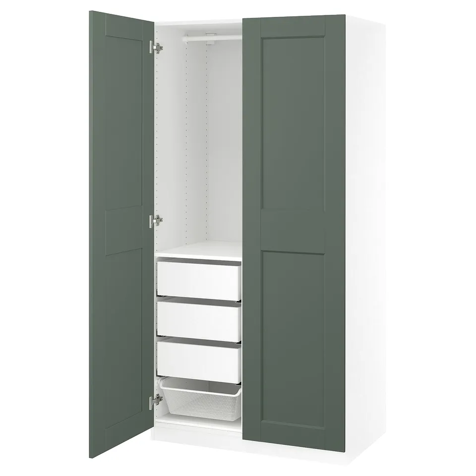 Open green and white wardrobe PAX showcasing shelves and baskets.