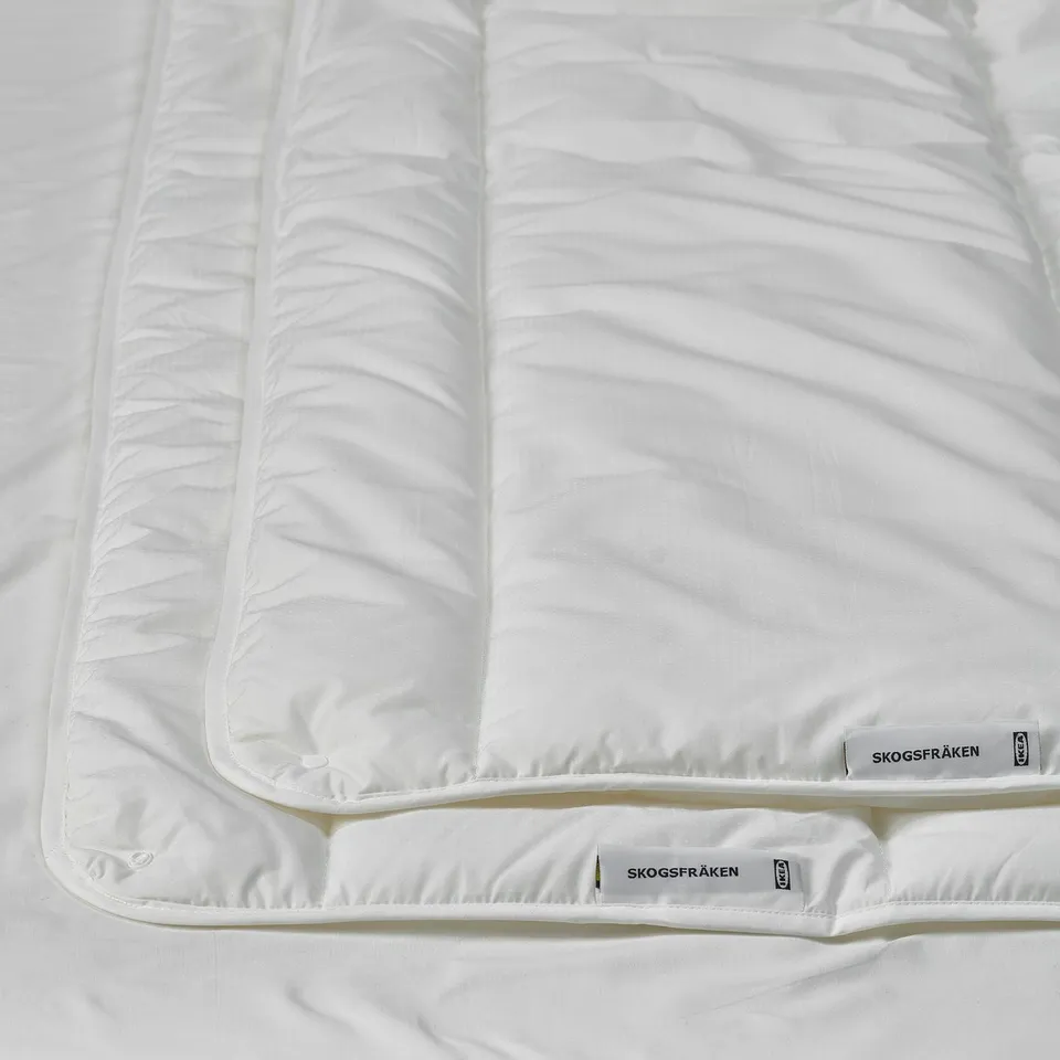 White SKOGSFRÄKEN duvet close-up, smooth texture, eco-friendly tags.