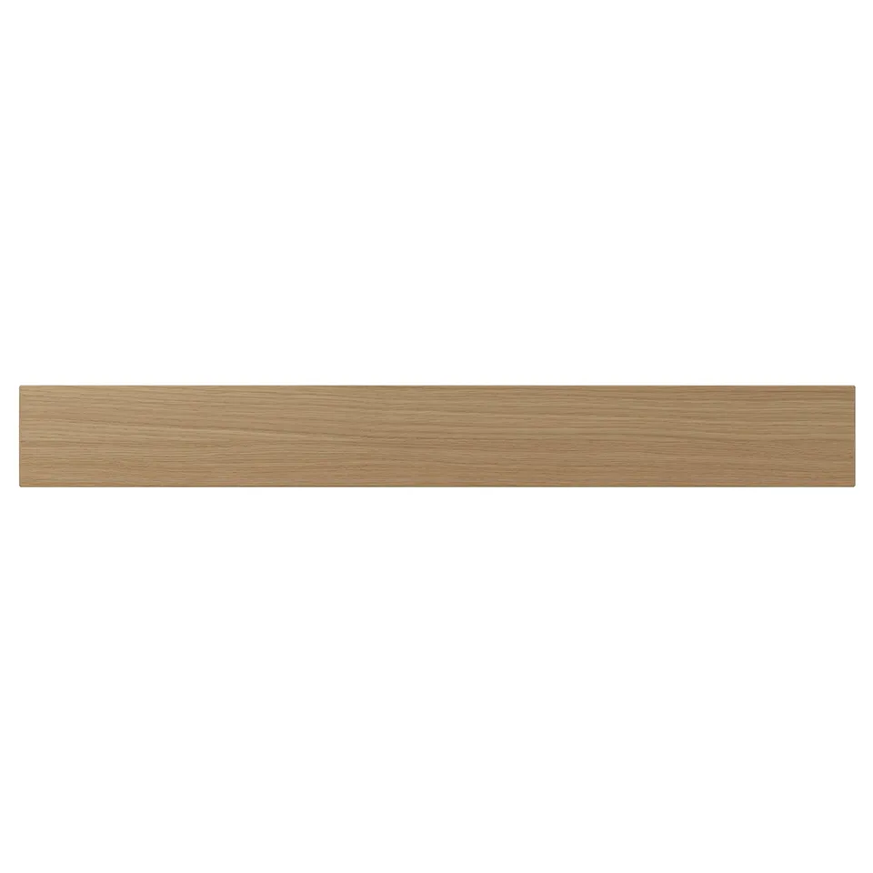 A VEDHAMN kitchen drawer front in natural wood. It is rectangular with visible oak grain, framed by solid wood, and lacquered for durability.