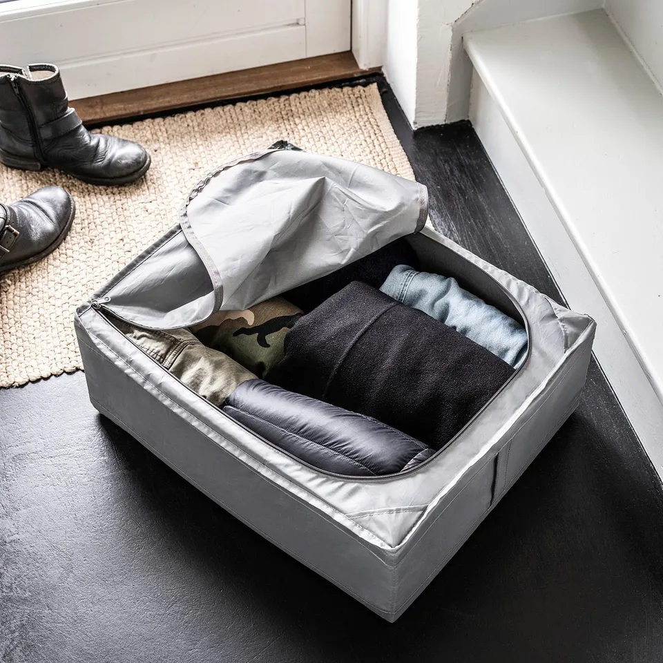 SKUBB storage case, grey, fabric with ventilation, rectangular, open with clothes inside.