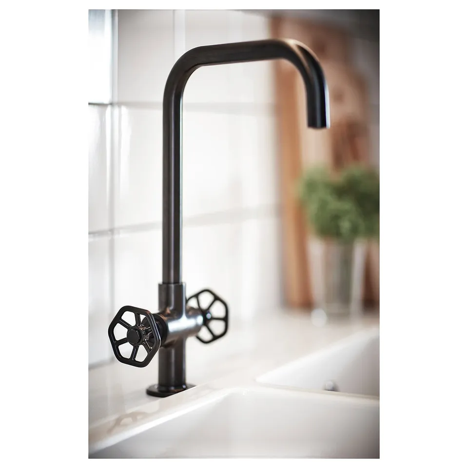 Black GAMLESJÖN tap on white sink, tall curved spout, hex wheel handles.