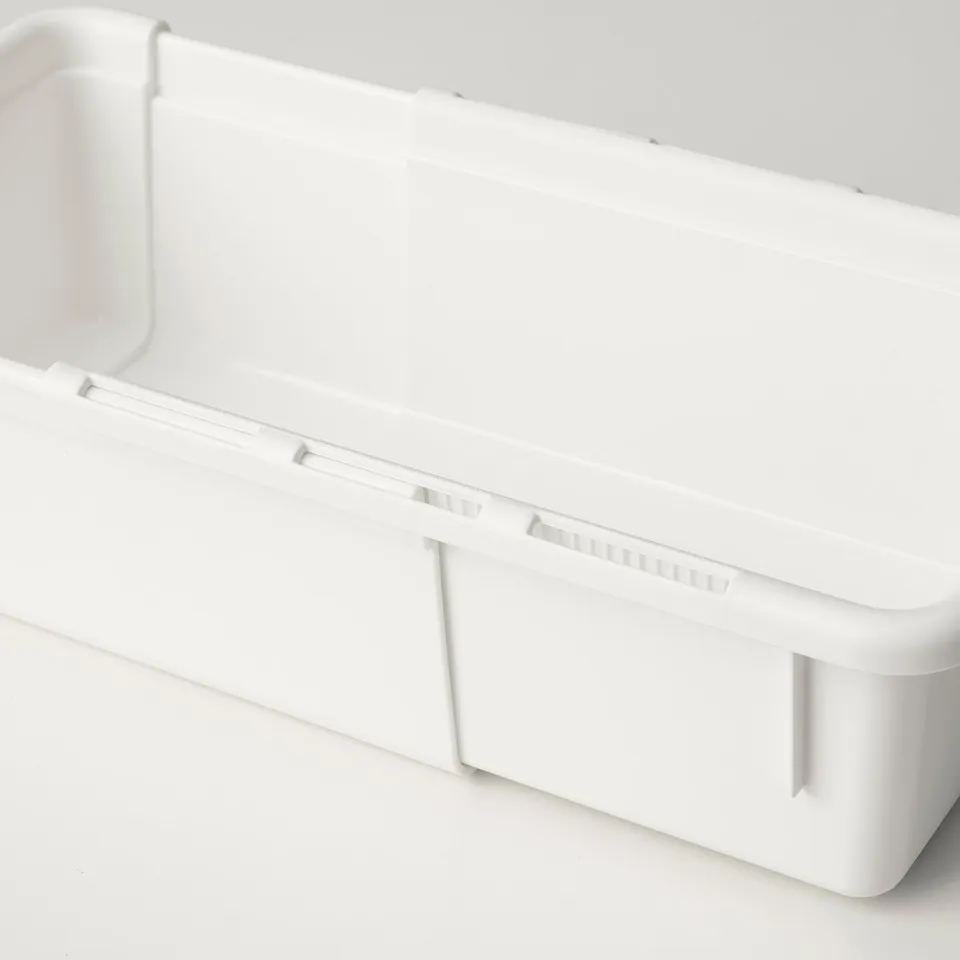 Clean, minimalist, white plastic storage box with extendable design, shown partially extended on a light surface.