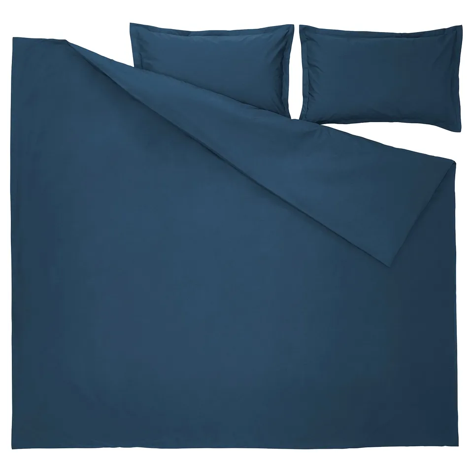 A neatly arranged dark blue duvet cover set with matching pillows. Its made of 100% cotton, featuring a crisp percale weave for a luxurious feel.